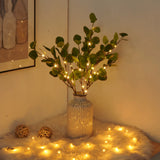 Ramo de oliveira com luzes decorativas